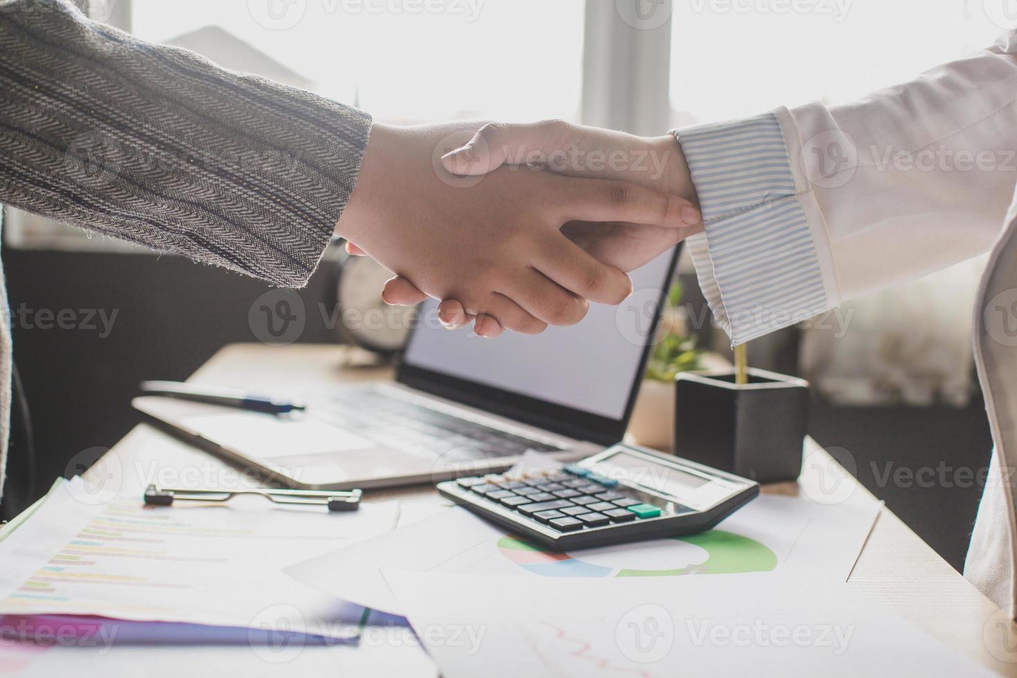 Hand of business woman handshake for teamwork of business merger and acquisition, successful negotiate, hand shake, shake hand with partner to celebration partnership and business deal concept photo