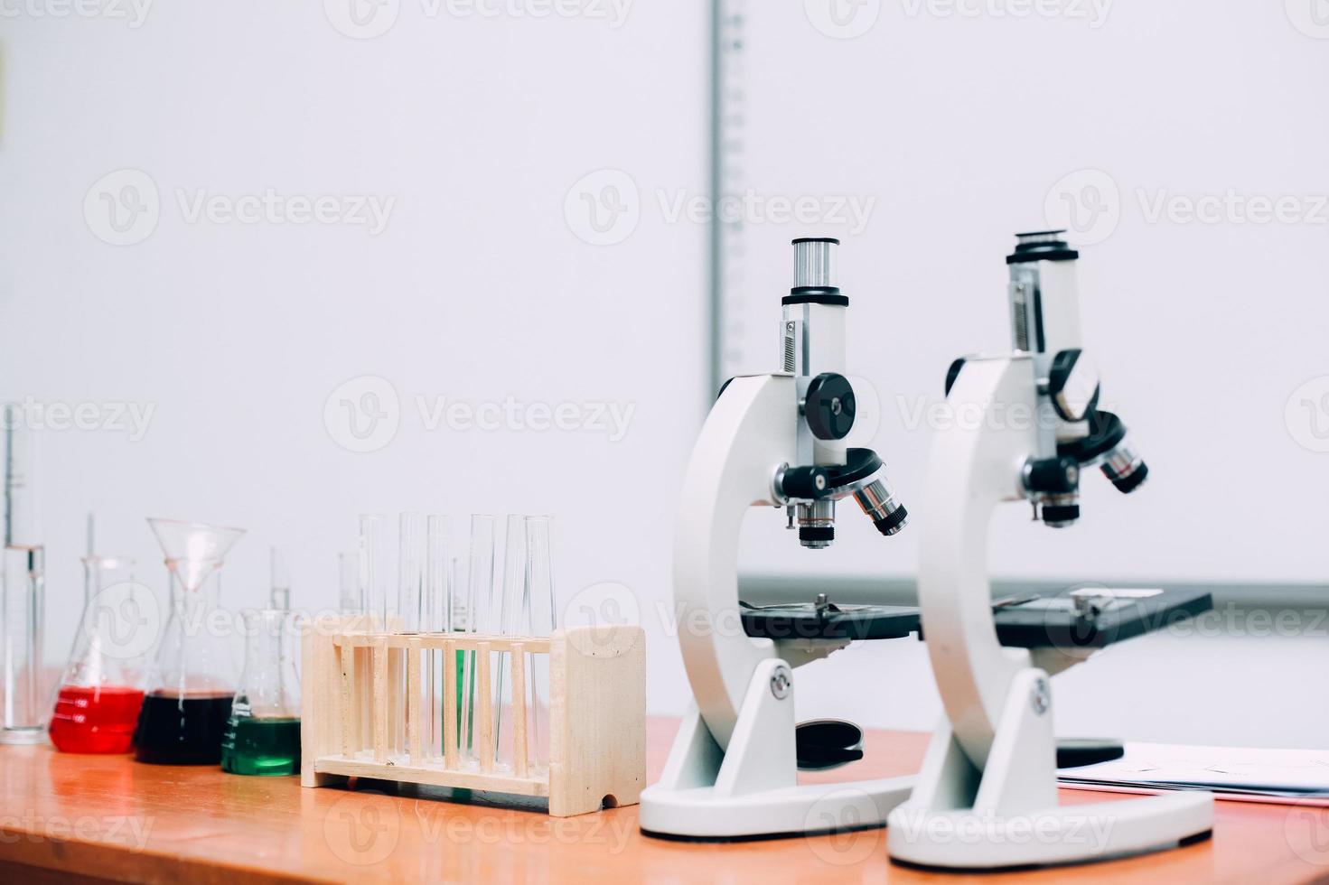 Microscope on table with laboratory equipment in chemical lab. National Science Day, World Science Day photo