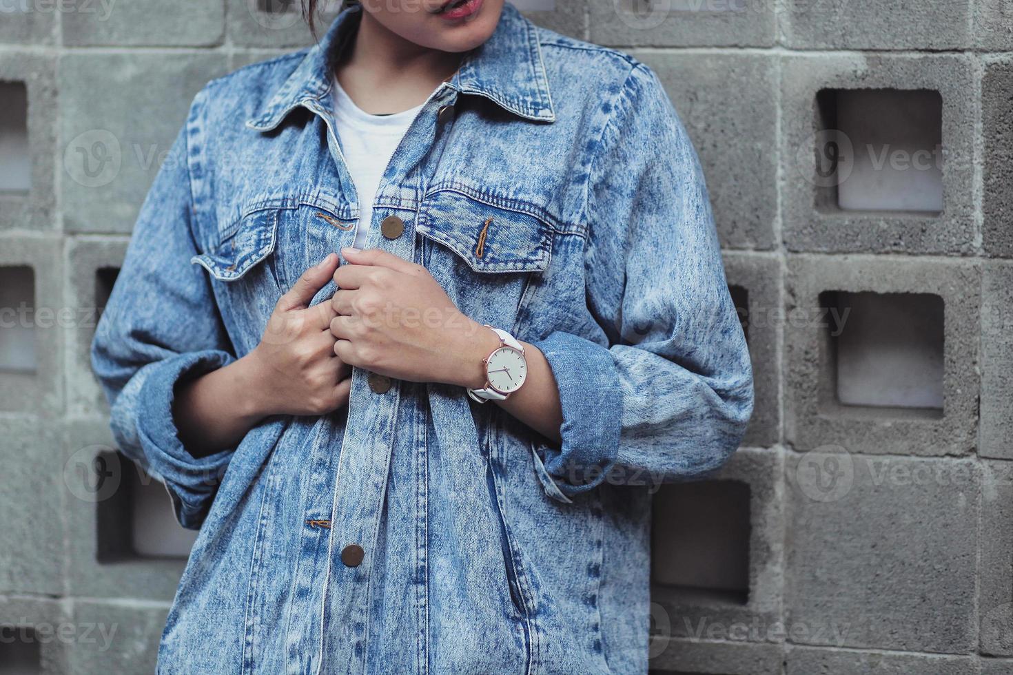 Cropped shot of woman in denim jacket photo