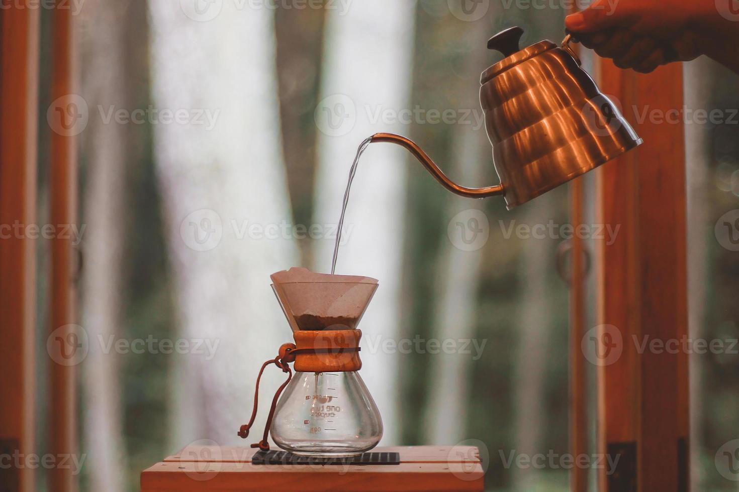 Barista hand Pour over V60 funnel and server. photo