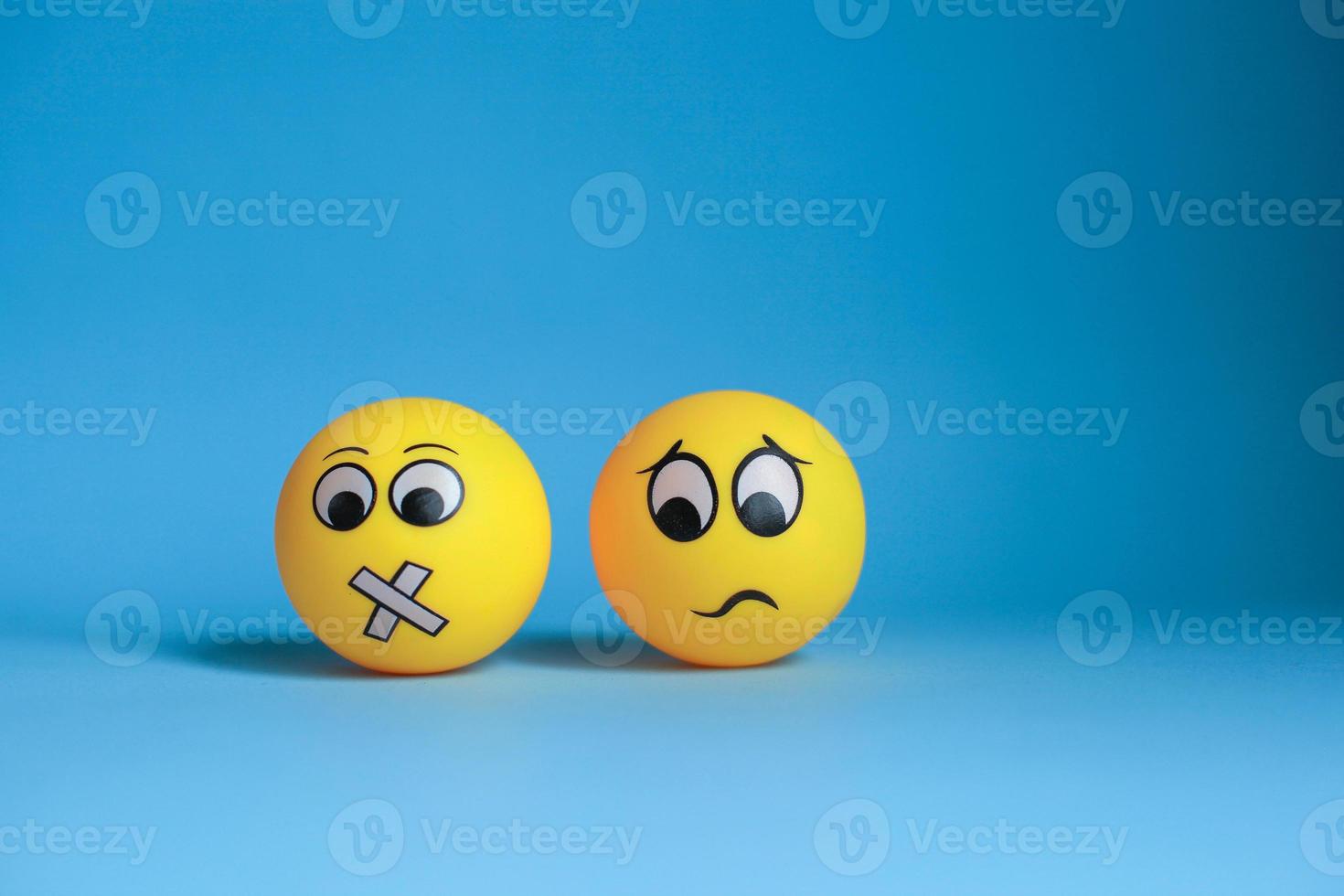 Silent face emoticon with confused emoticon isolated on blue background photo