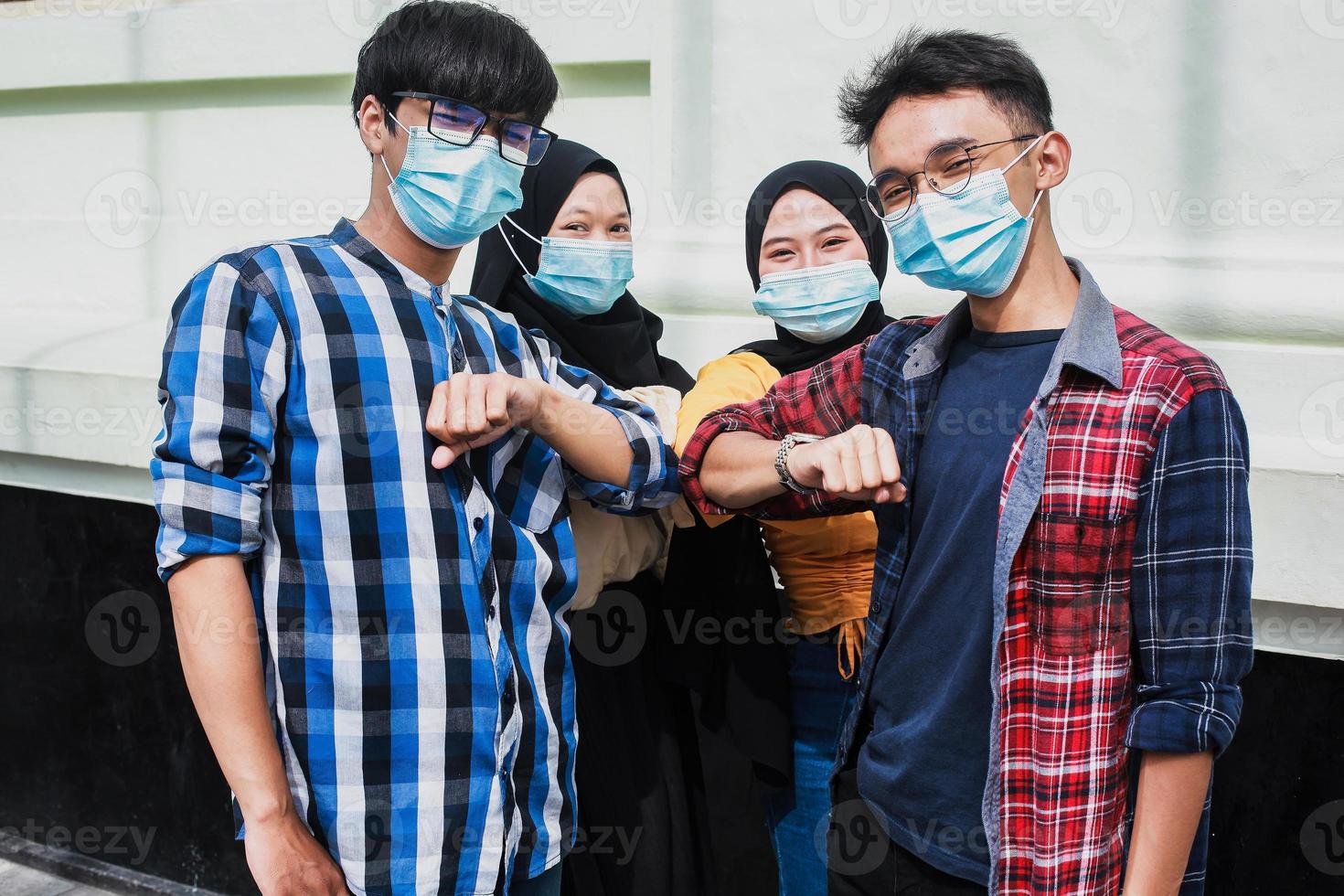Group of friends bump elbows to avoid corona virus photo