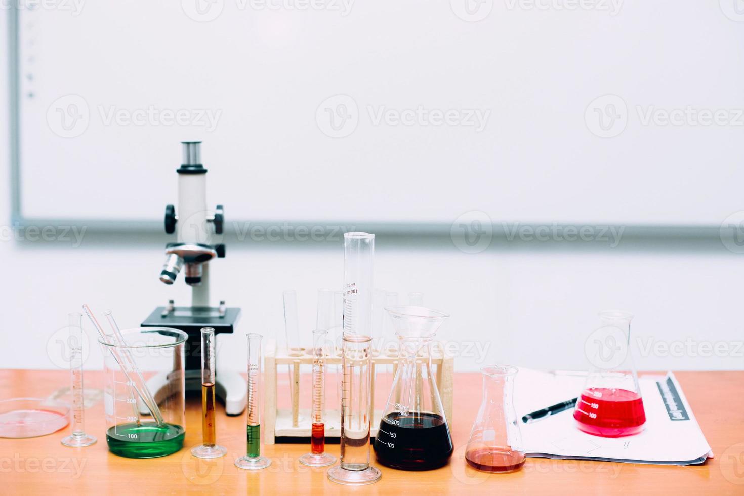 Experimental equipments in scientific laboratory. The lab has microscope, glass tube full of colorful chemical substances. National Science Day, World Science Day photo