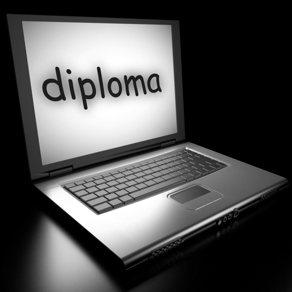 palabra de diploma en la computadora portátil foto