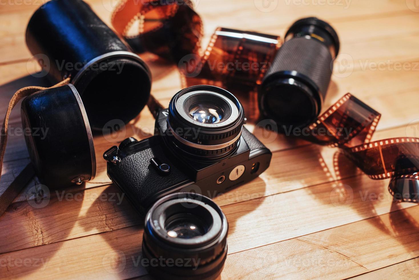 Old photo film and analog camera on table. Roll of photographic . Beautiful vintage design.