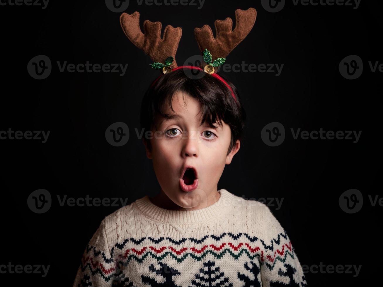 surprised child with wearing reindeer photo