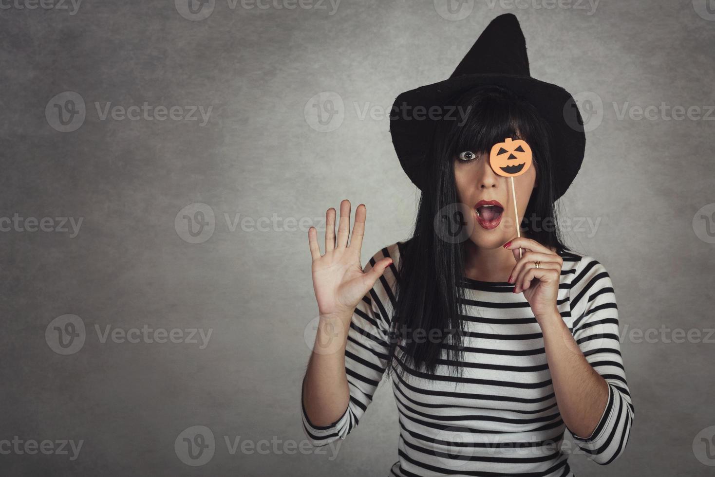 Young woman holding a pumpkin in halloween photo