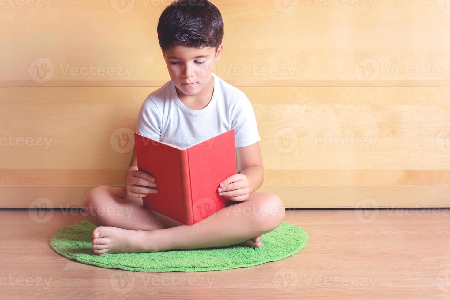 boy reading a book photo