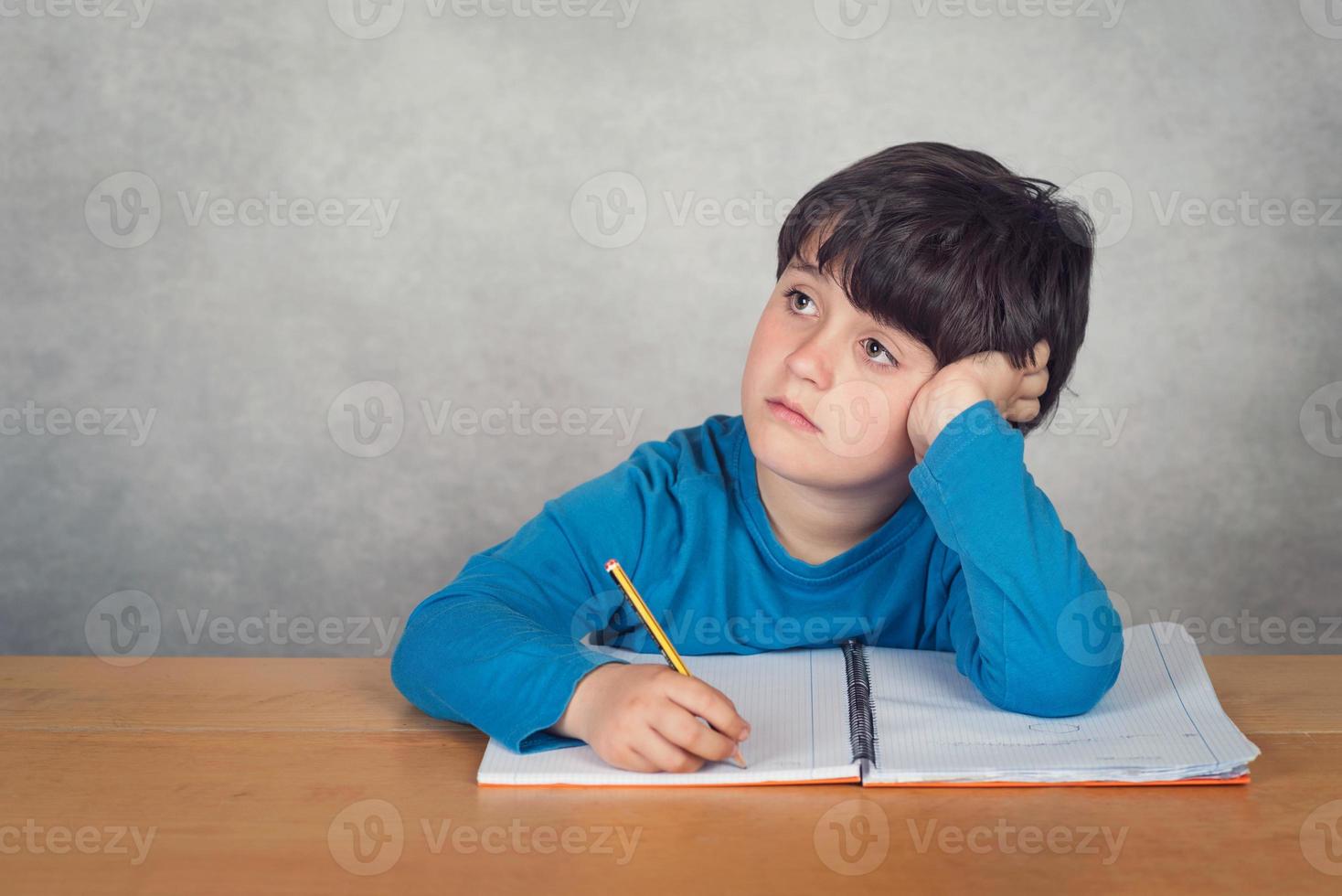 sad and pensive boy with a book photo