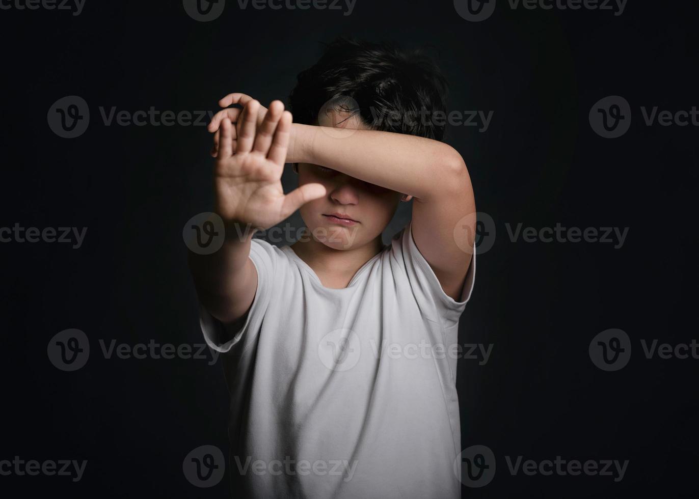 crying child showing a stop sign photo