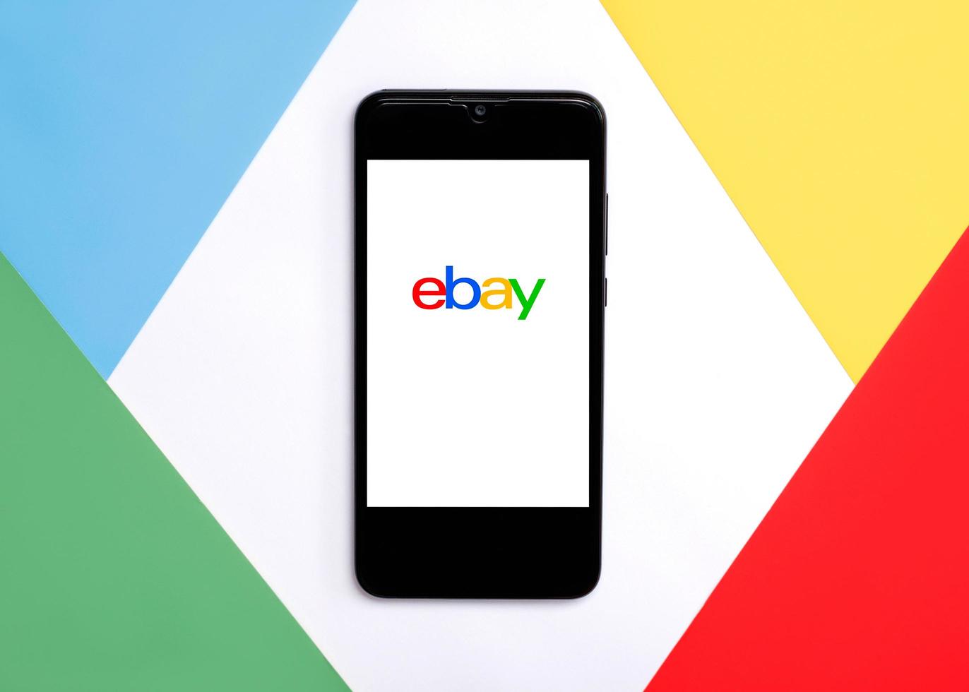 Ebay logo on white screen of smartphone.Ebay app photo