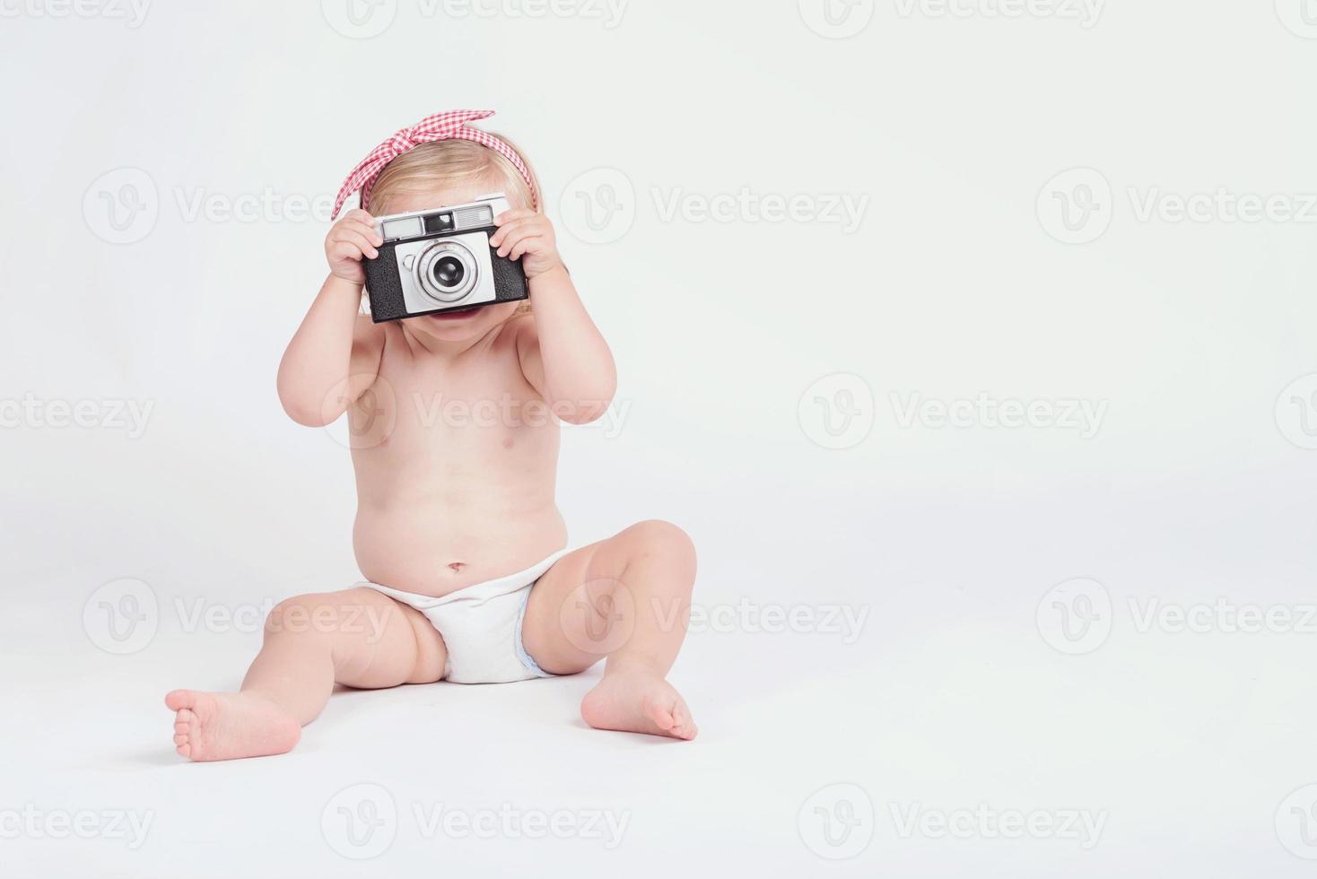 baby girl with retro camera photo