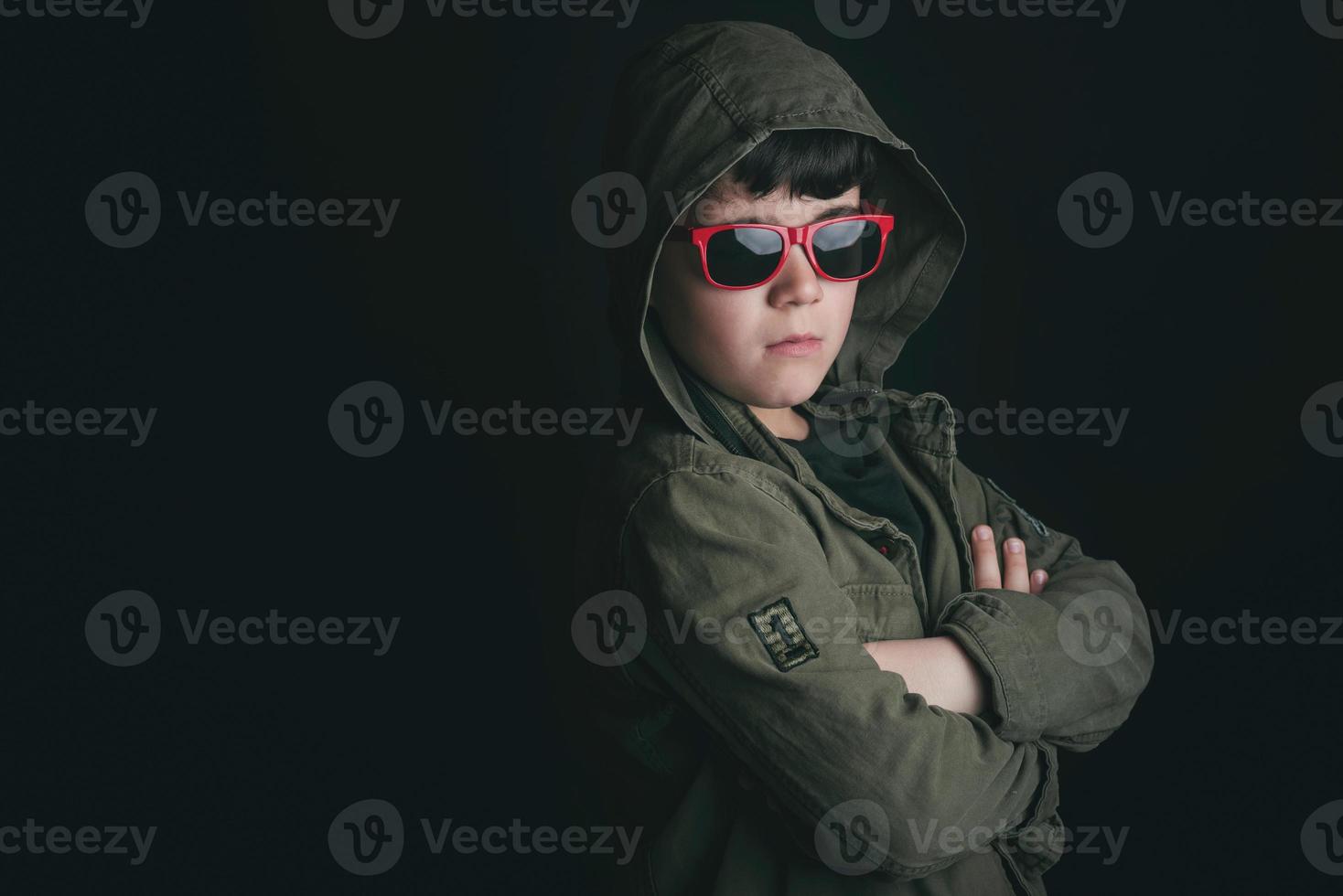 Sad child with sunglasses photo