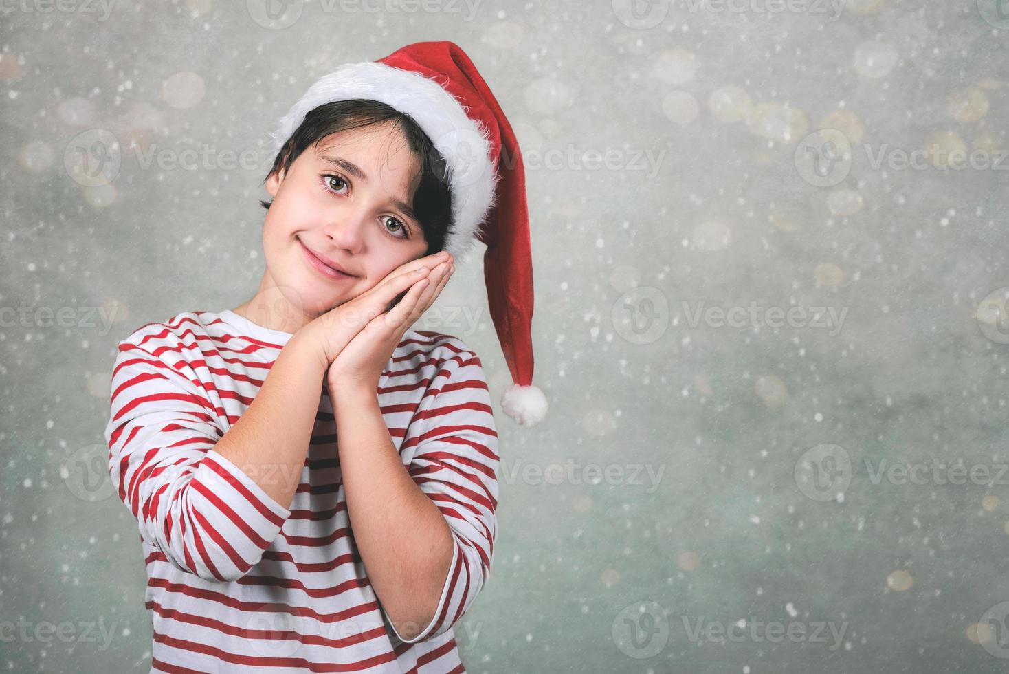 feliz navidad, niño sonriente con sombrero de santa claus de navidad foto