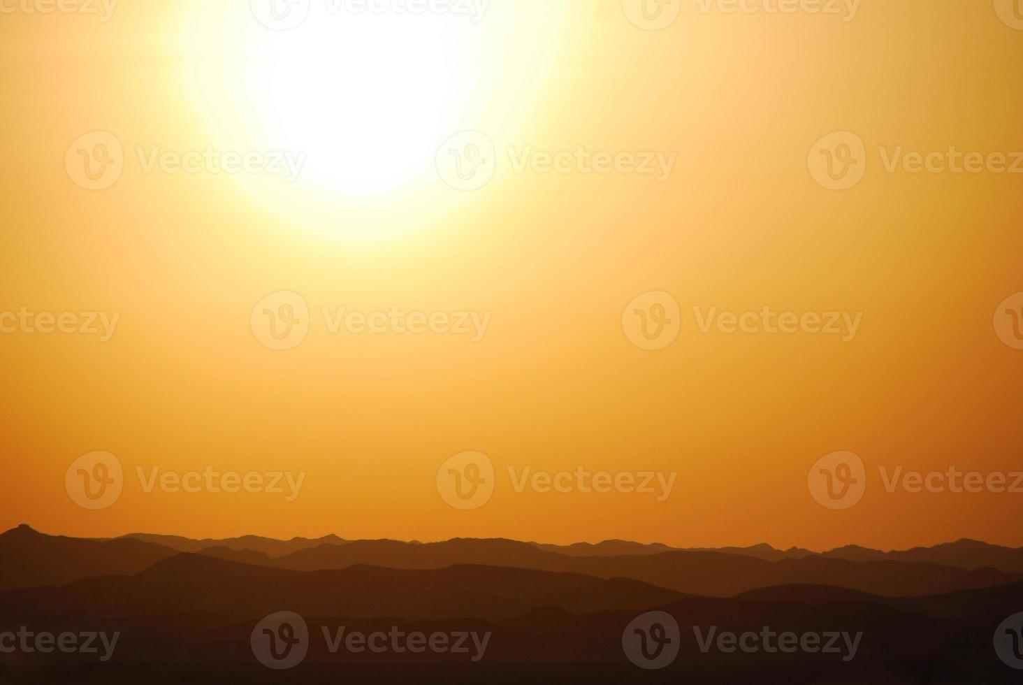 sunset with mountain in the desert photo
