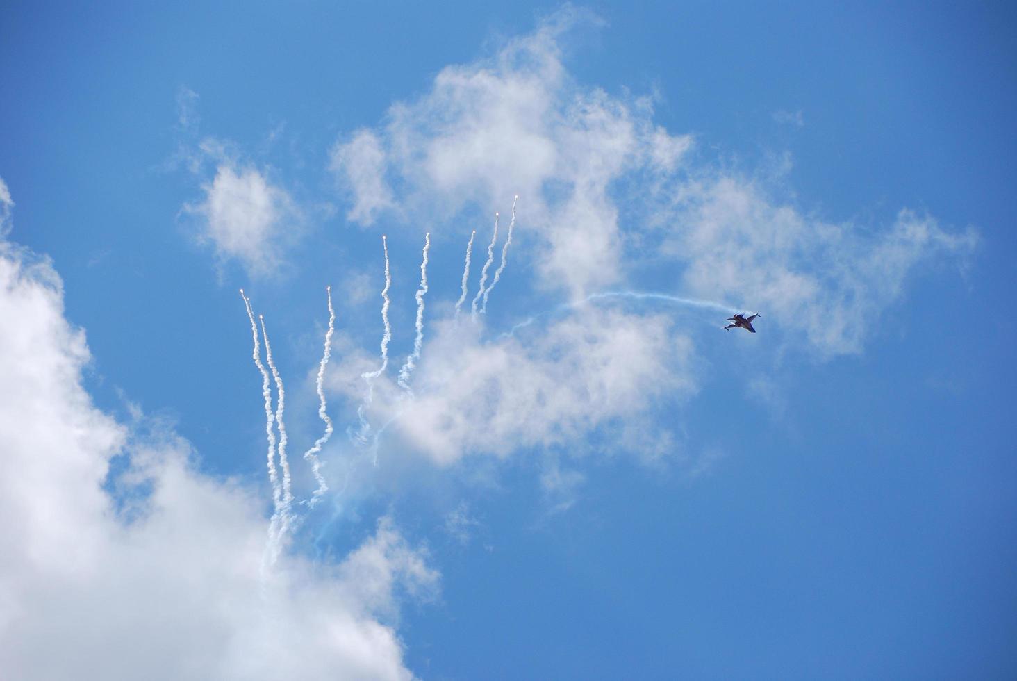 plane fighter makes many distractions at an air show photo