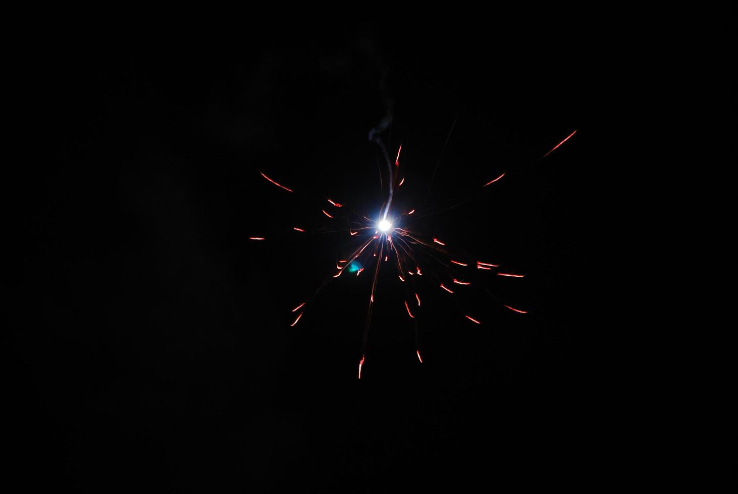 a single small explosion during a fireworks display on new year's eve photo