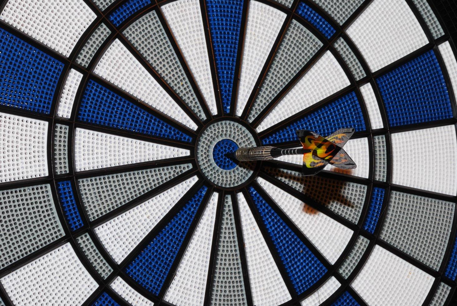 an arrow hit the bullseye in a darts photo