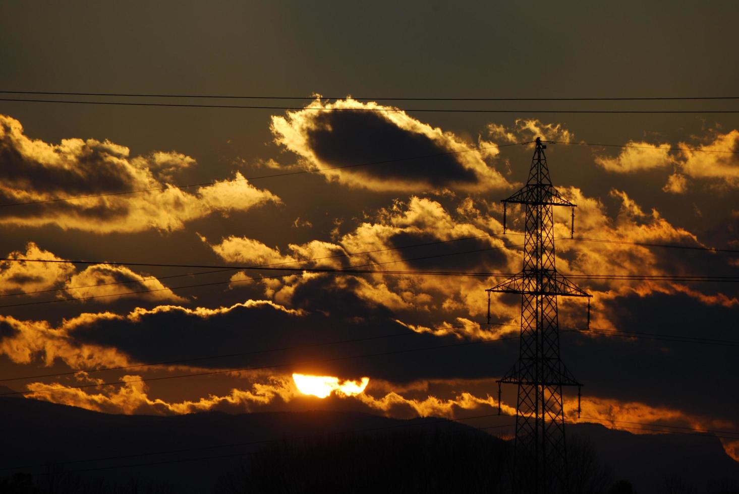 sunset with electricity pylon photo