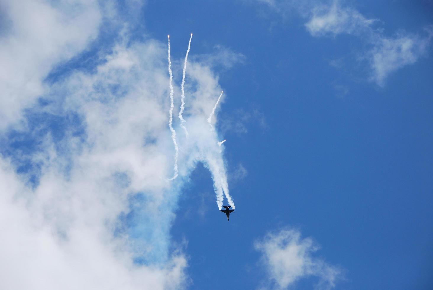 faster jet fighter flies quickly downwards with decoy photo