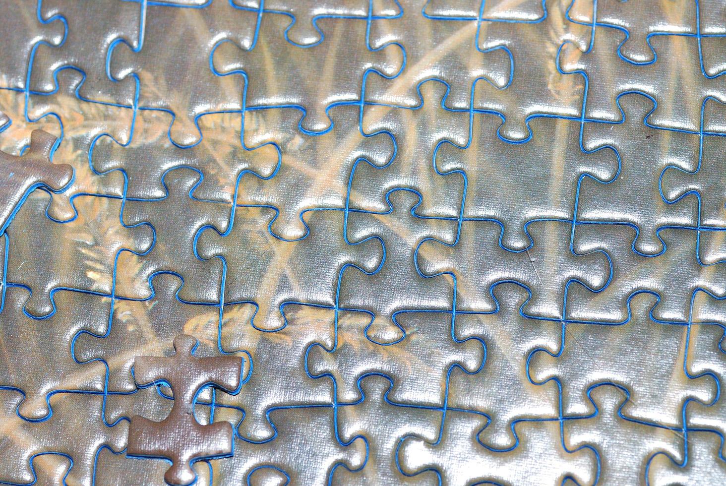 many puzzle pieces with blue border connected photo