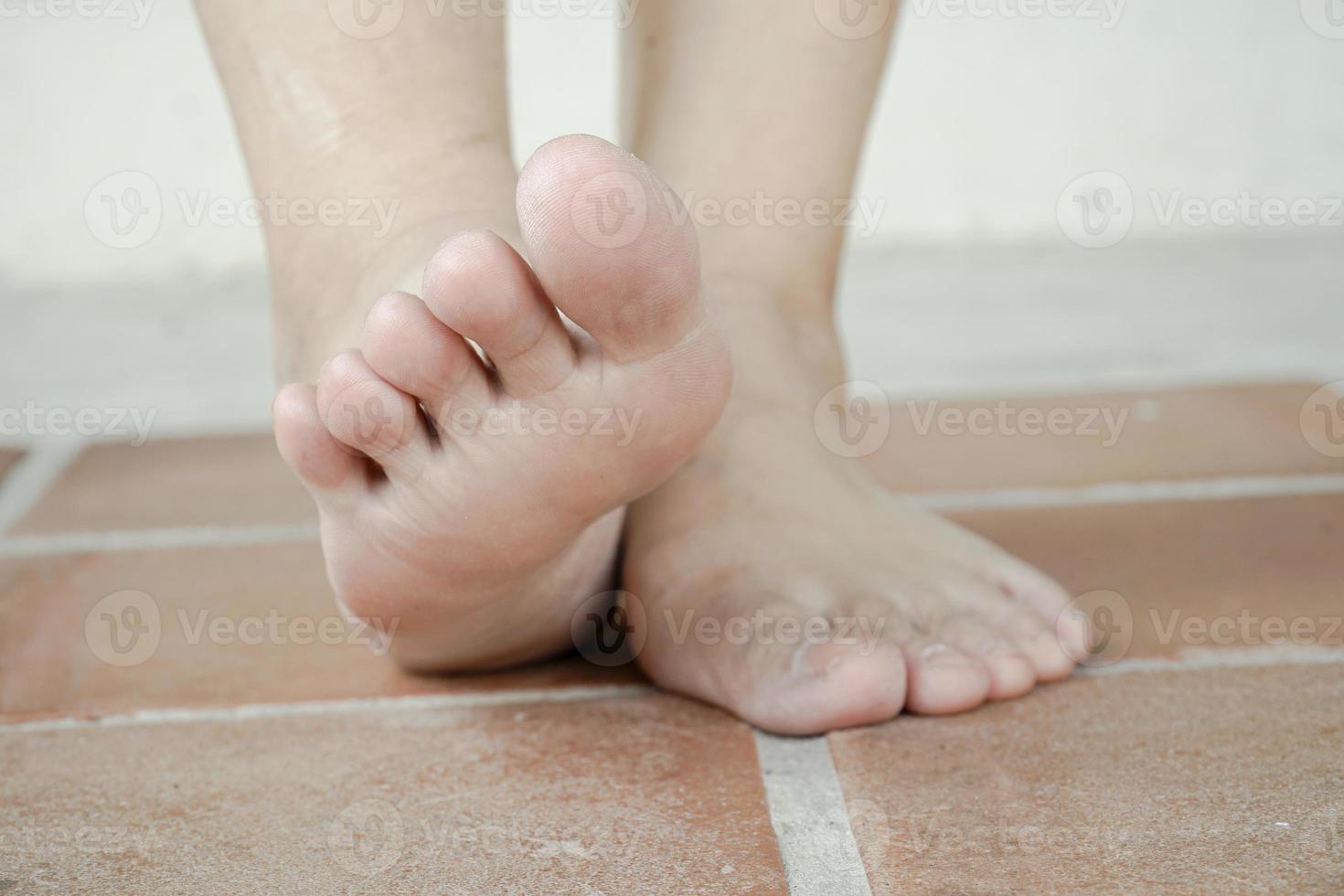 Walking bare feet, close up. Floor heating concept. photo