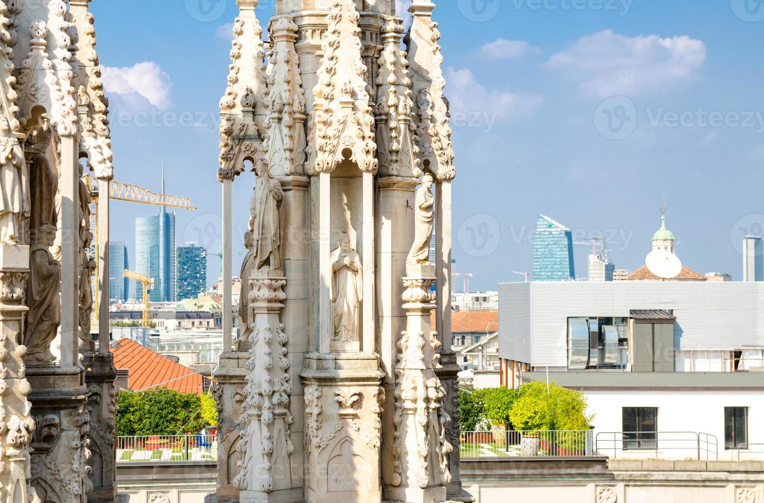 White marble statues on roof of Duomo di Milano Cathedral, Italy photo