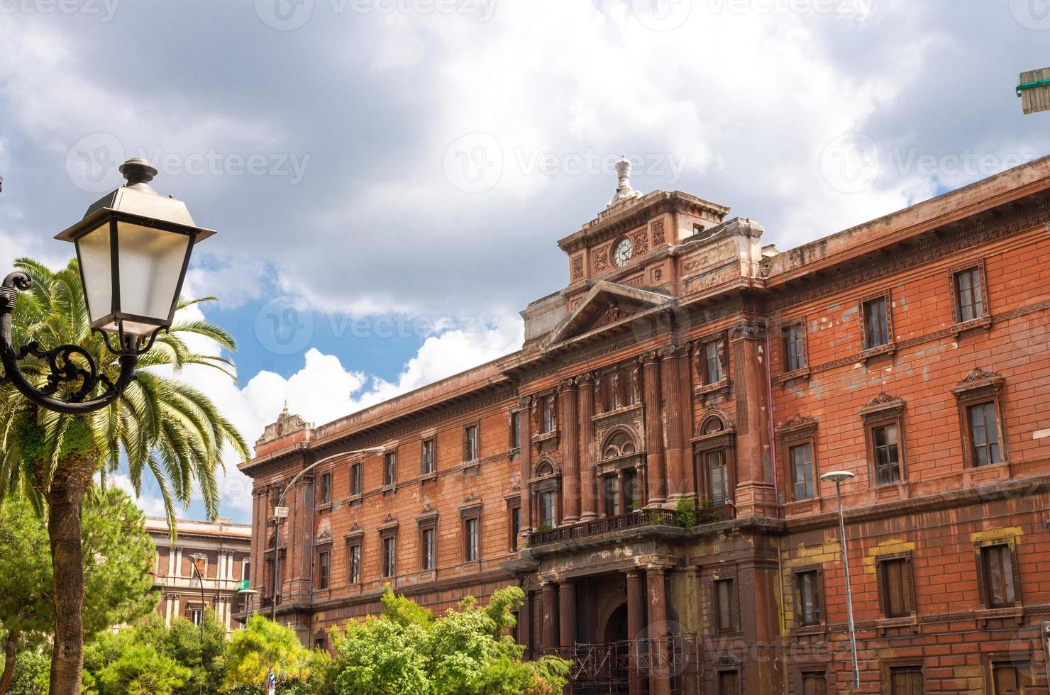 ld red brown brick building with clock watch, Taranto, Puglia, Italy photo