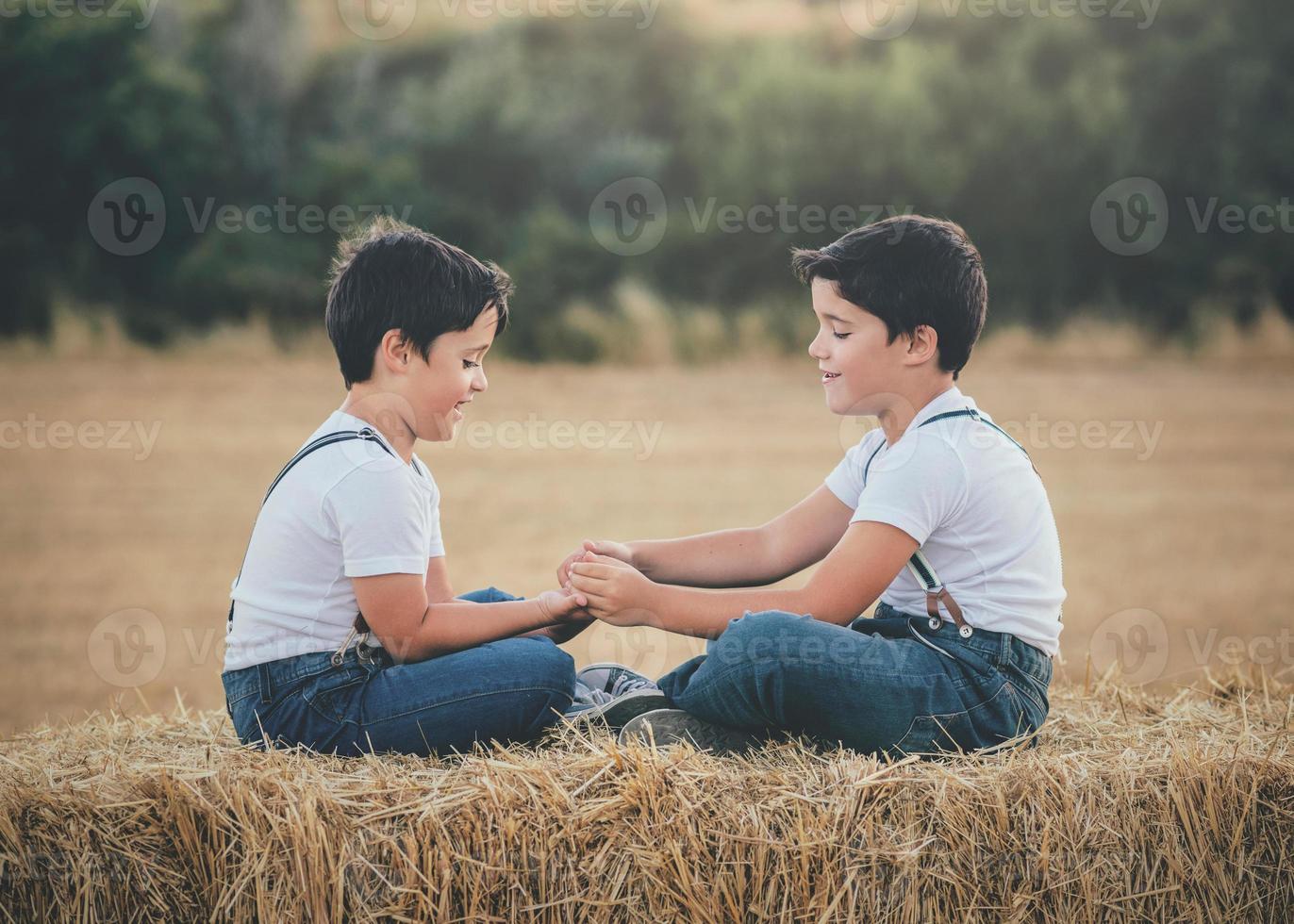 hermanos jugando en el campo de trigo foto