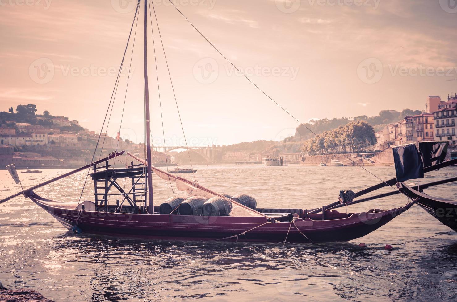 Portugal, old look of Porto , panoramic view of Douro river, red wooden boat with wine port barrels photo