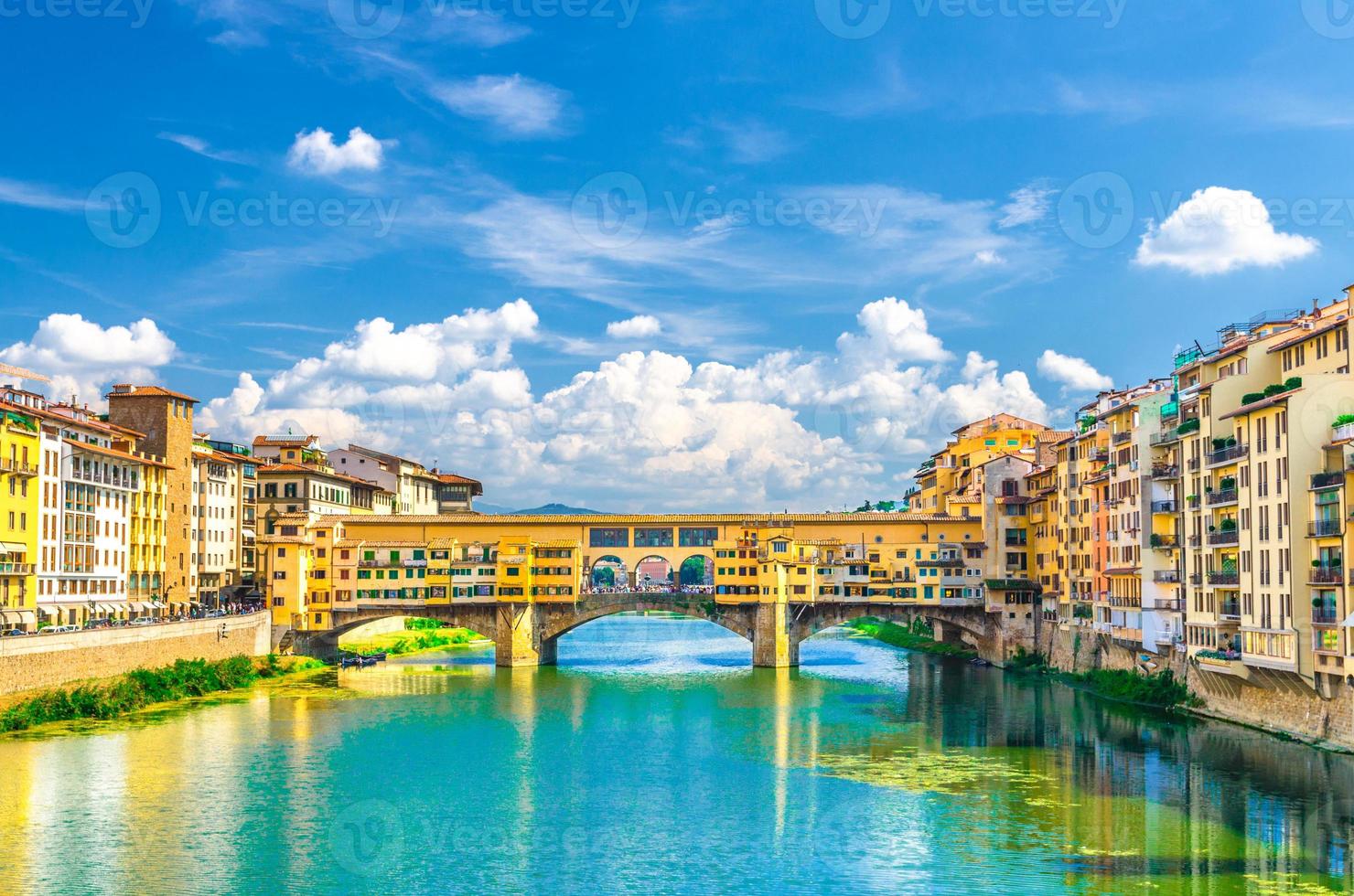 Ponte Vecchio stone bridge with colourful buildings houses over Arno River photo