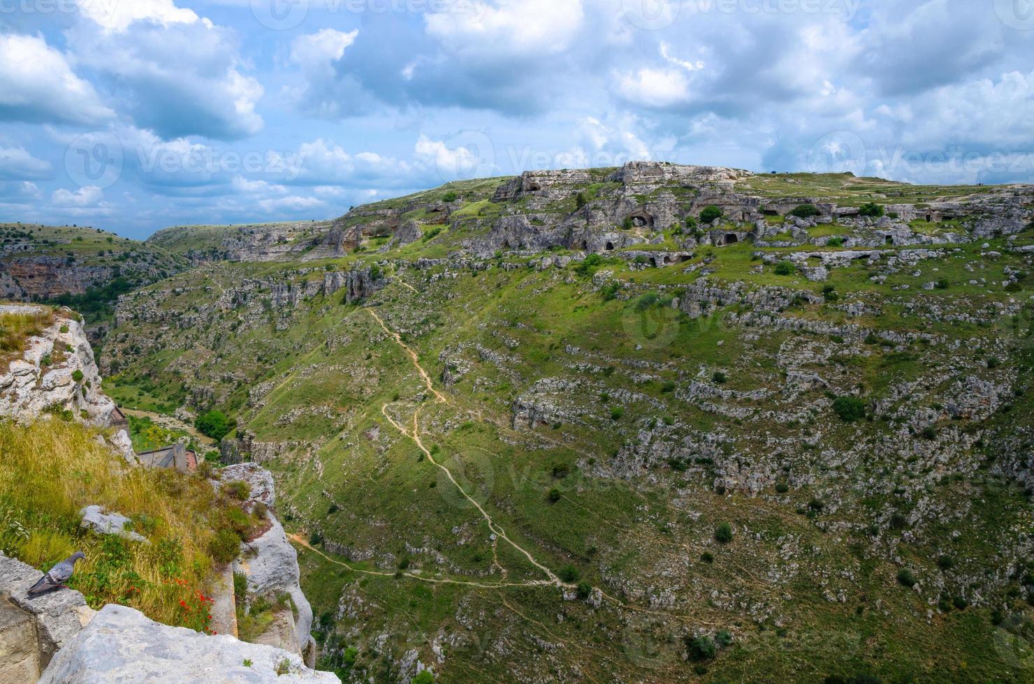 View of canyon with rocks and caves Murgia Timone, Matera Sassi, Italy photo