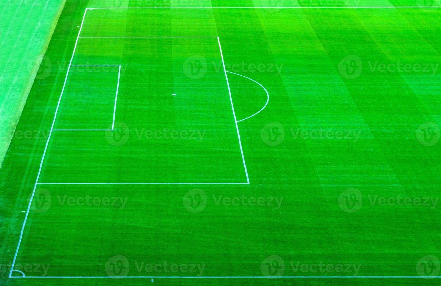 Top aerial view of football pitch soccer field with green grass lawn photo