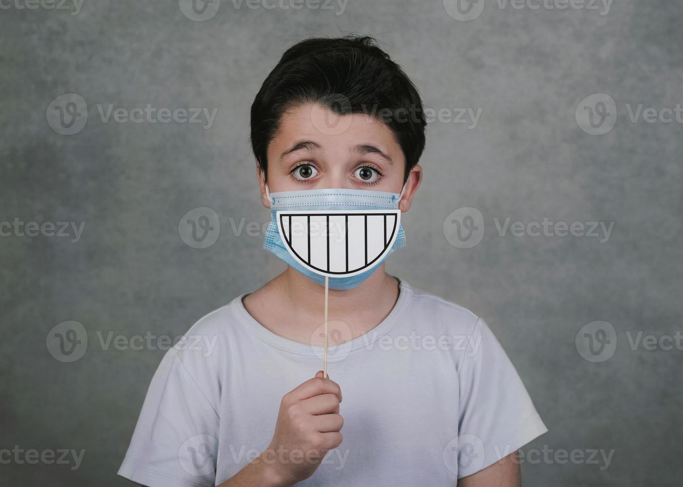 kid with medical and smile false on stick photo