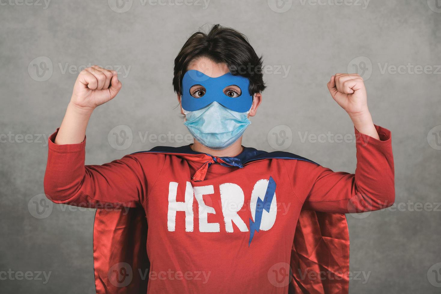 Coronavirus,kid with medical mask dressed as a superhero photo