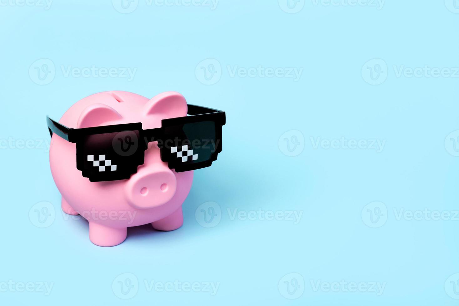 Pink piggy money bank with black sunglasses photo