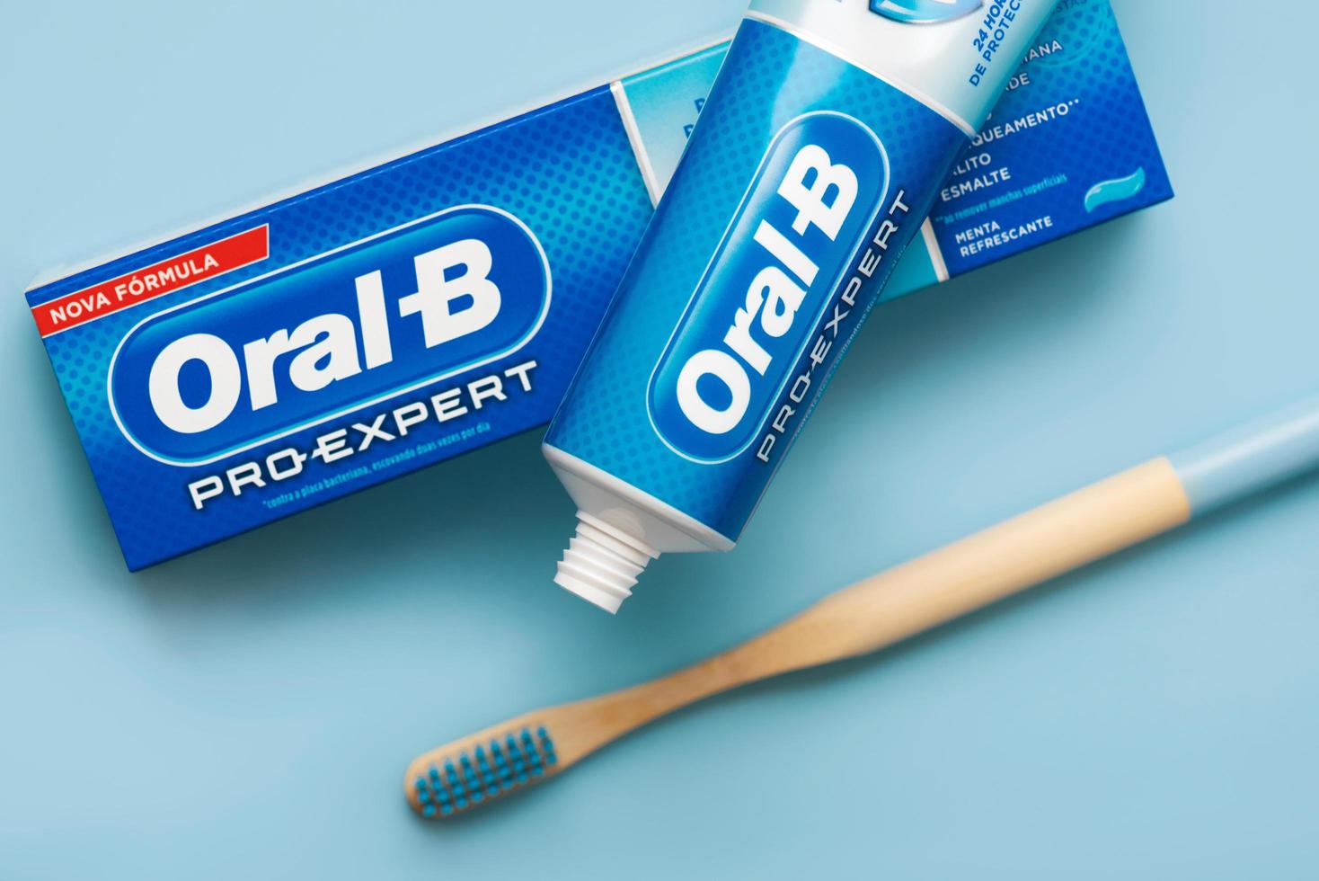 Carton box of Oral-B toothpaste with Oral B toothpaste and bamboo toothbrushe photo
