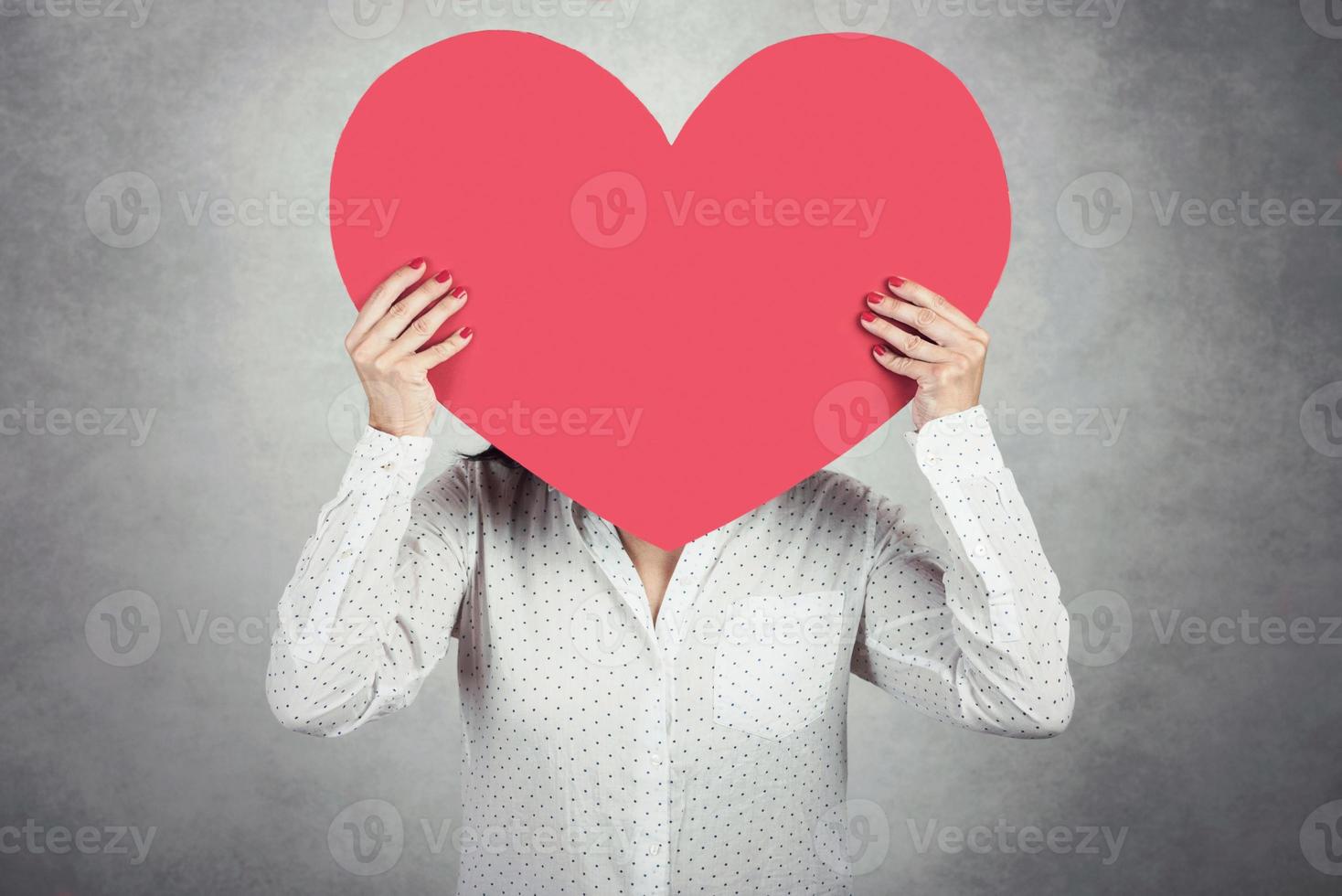 Young Woman holding red heart photo
