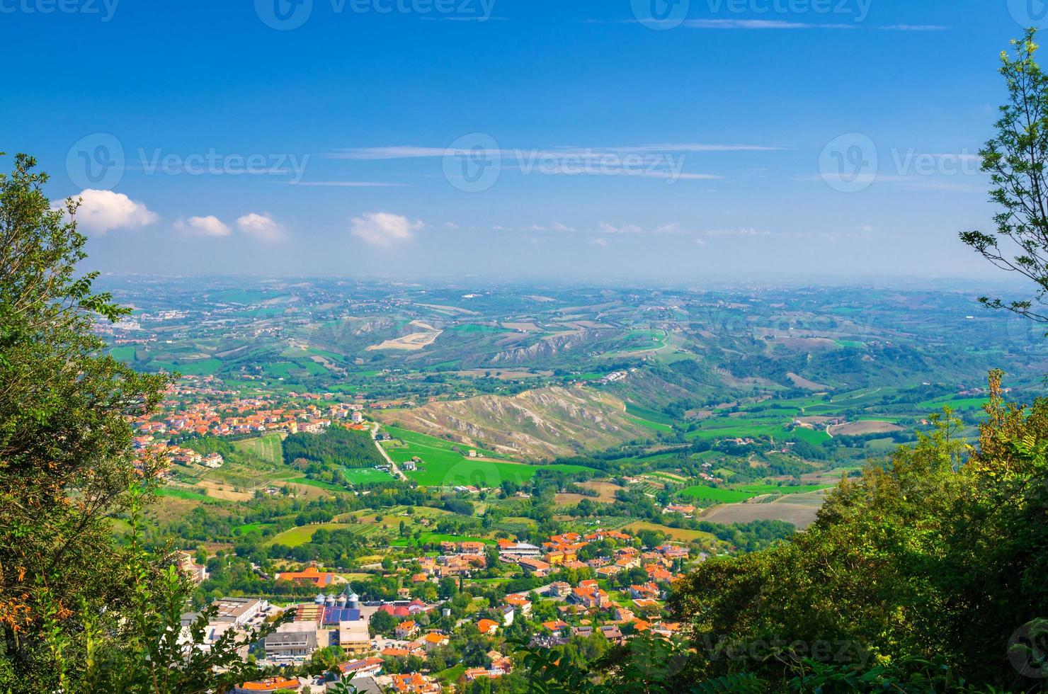Aerial top panoramic view of landscape with valley, green hills, fields and villages of Republic San Marino photo