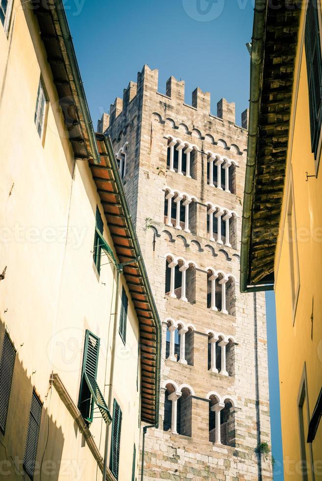 Bell tower of Chiesa di San Frediano catholic church view through narrow street in historical centre photo