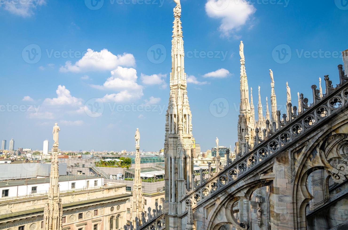 White marble statues on roof of Duomo di Milano Cathedral, Italy photo