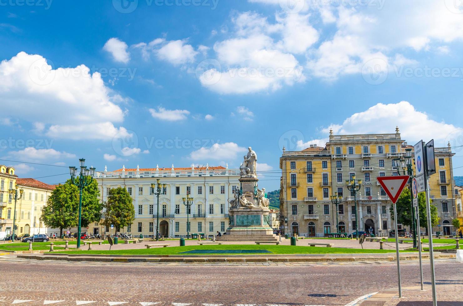 Monumento a Camillo Benso conte di Cavour statue on Piazza Carlo Emanuele II square with old buildings around photo