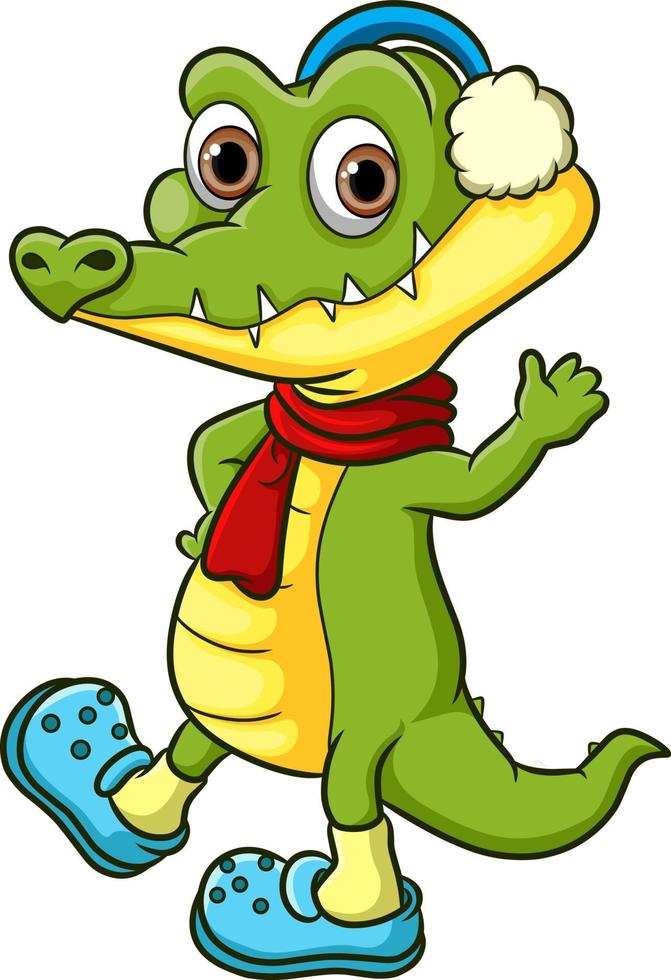 The crocodile is greeting and waving hand in the winter vector