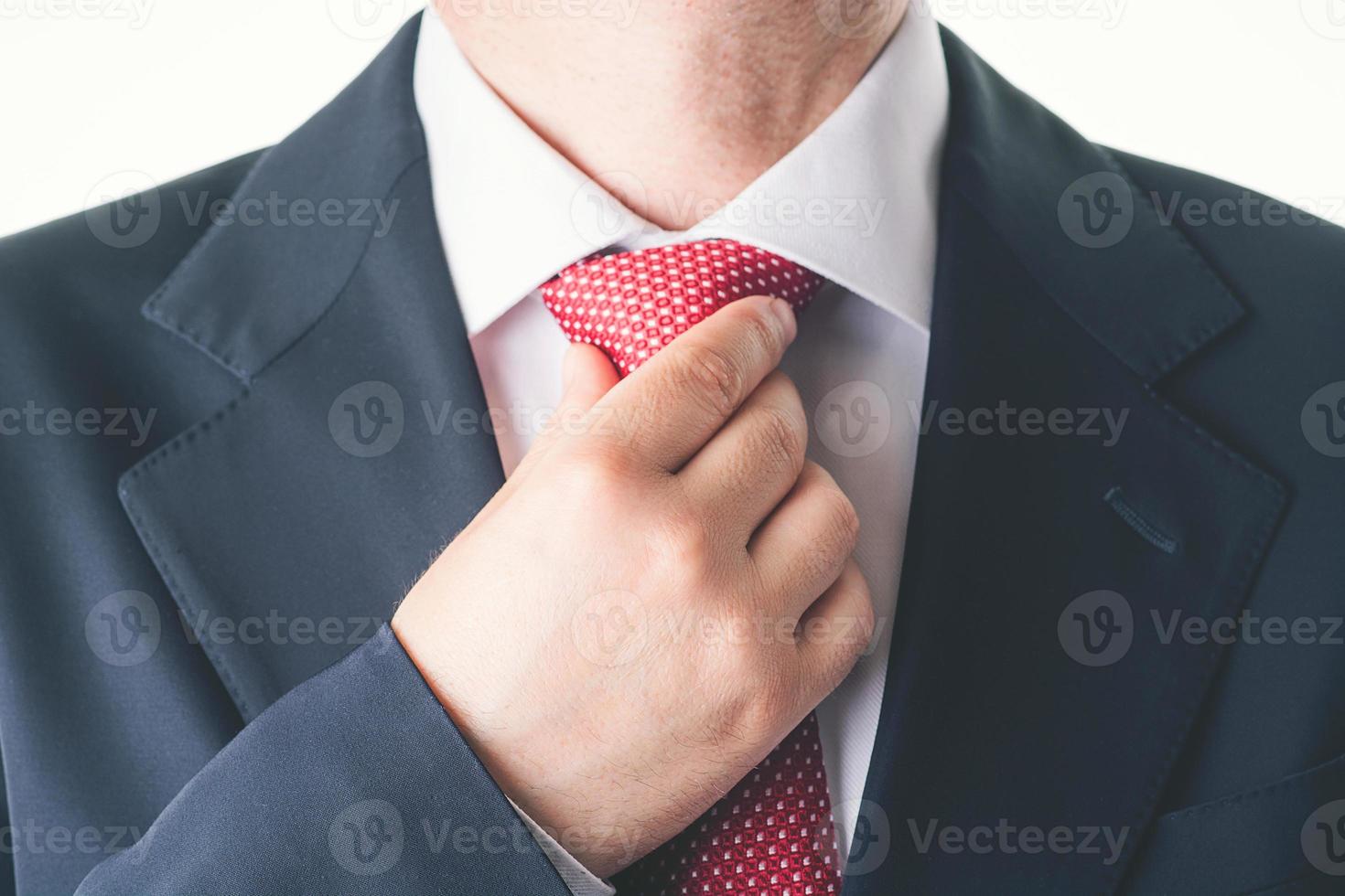 Businessman fixing his tie photo