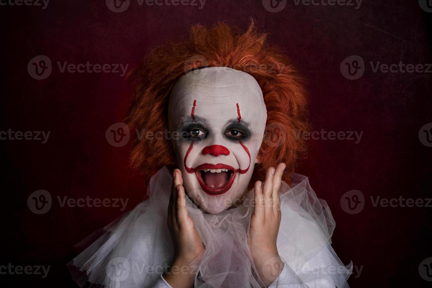 smiling boy dressed as a clown photo