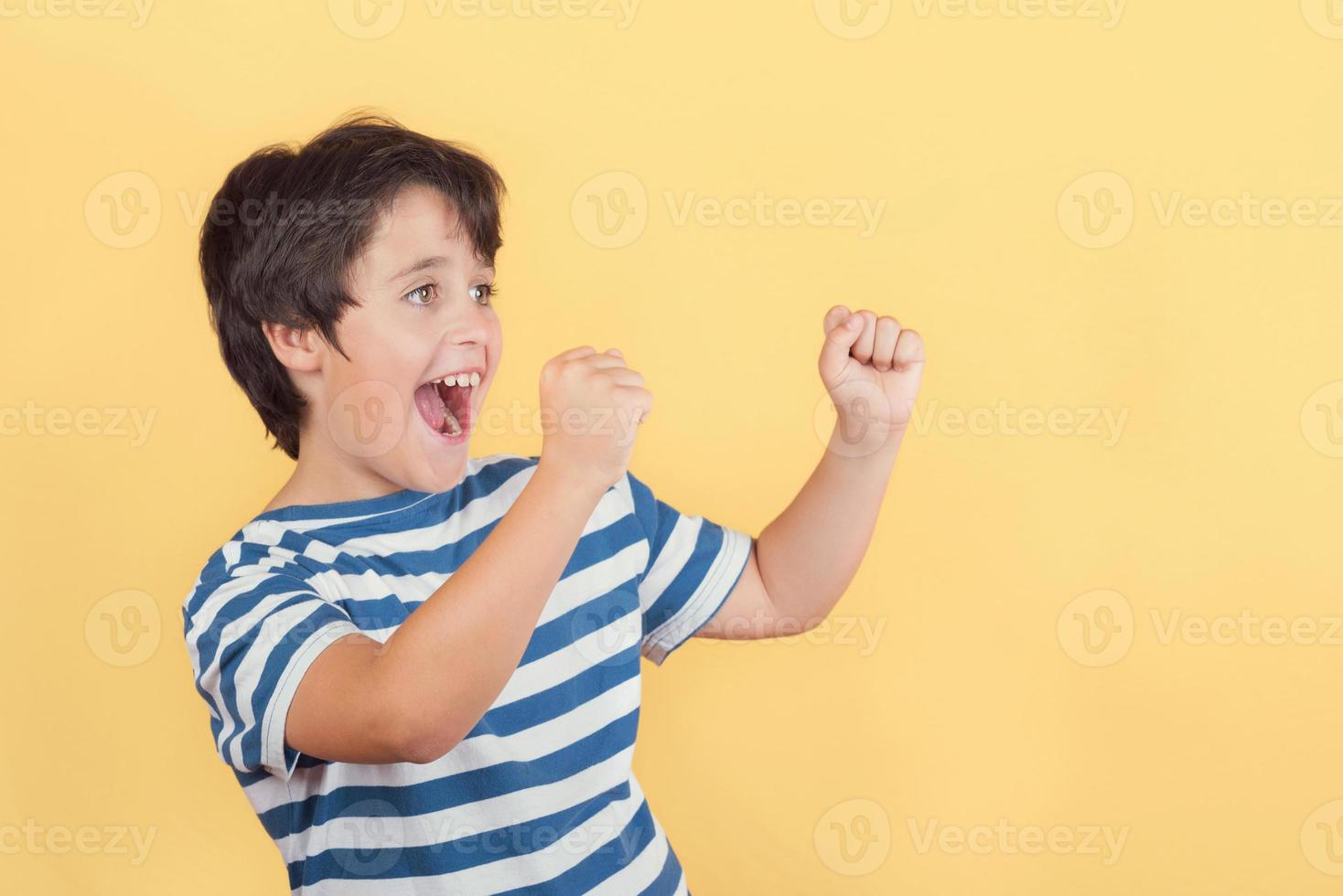 Funny child with hands in the air screaming photo