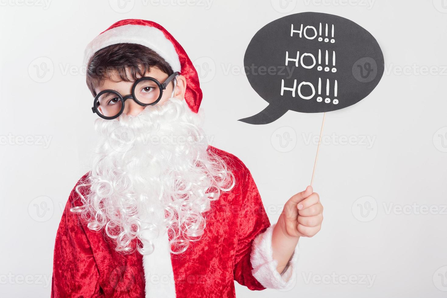 Boy dressed as Santa Claus photo