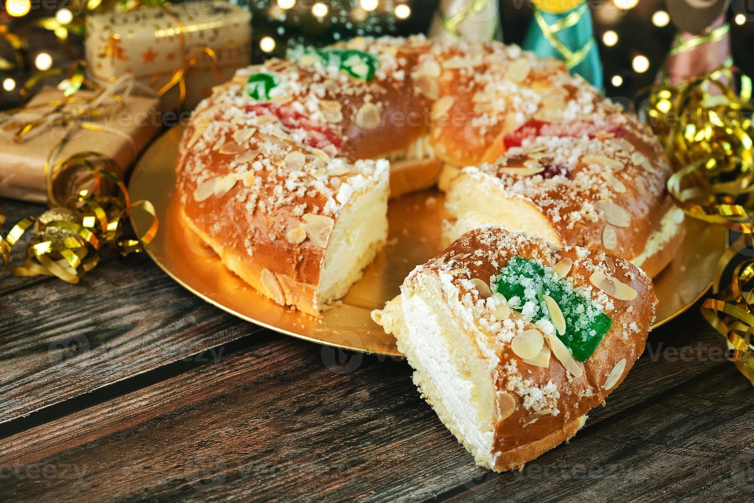 Roscon de reyes with cream and christmas ornaments. Kings day concept spanish three kings cake.Typical spanish dessert for Christmas. Selective focus photo
