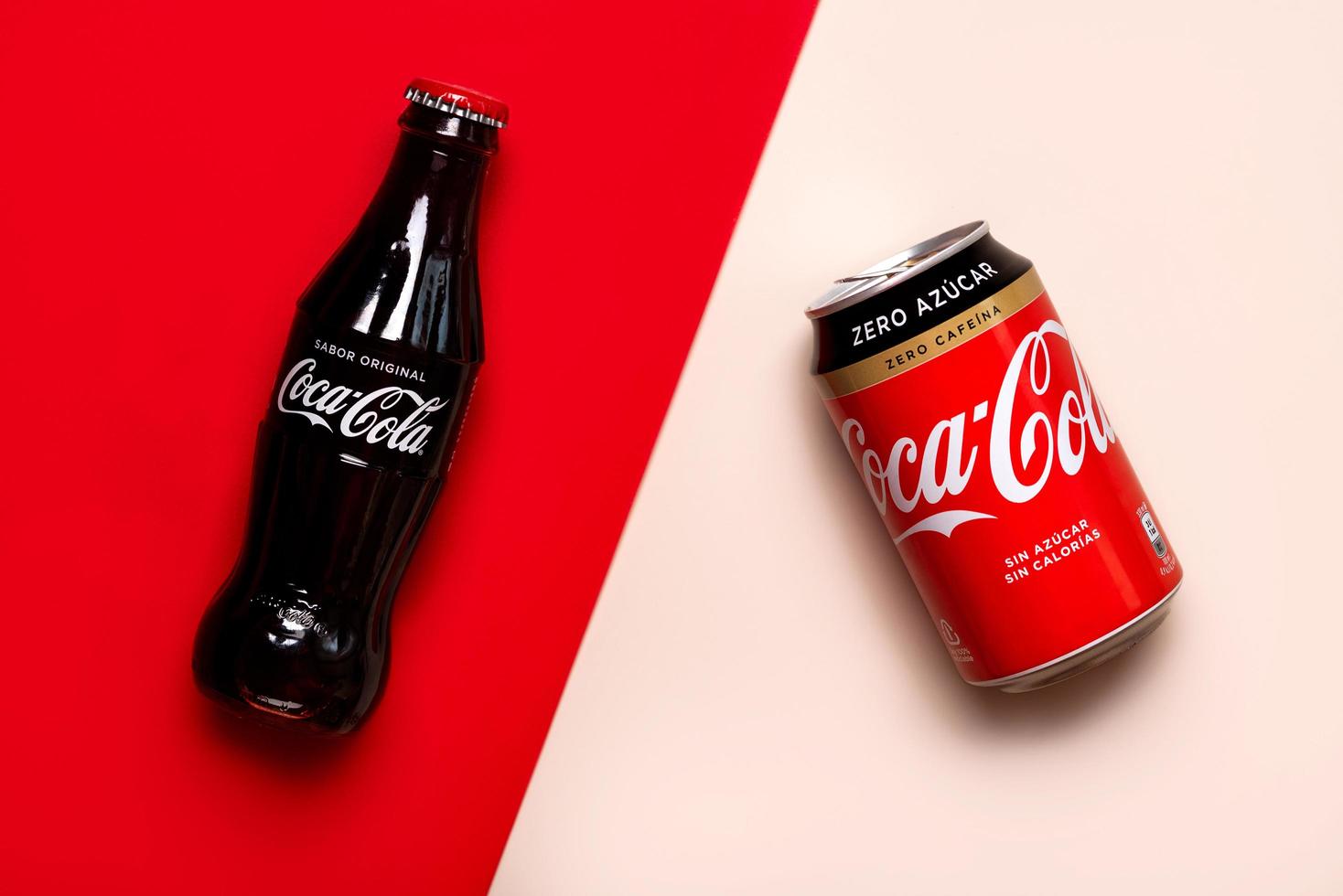 Classic glass bottle of Coca-Cola and can of Coca-Cola Zero photo
