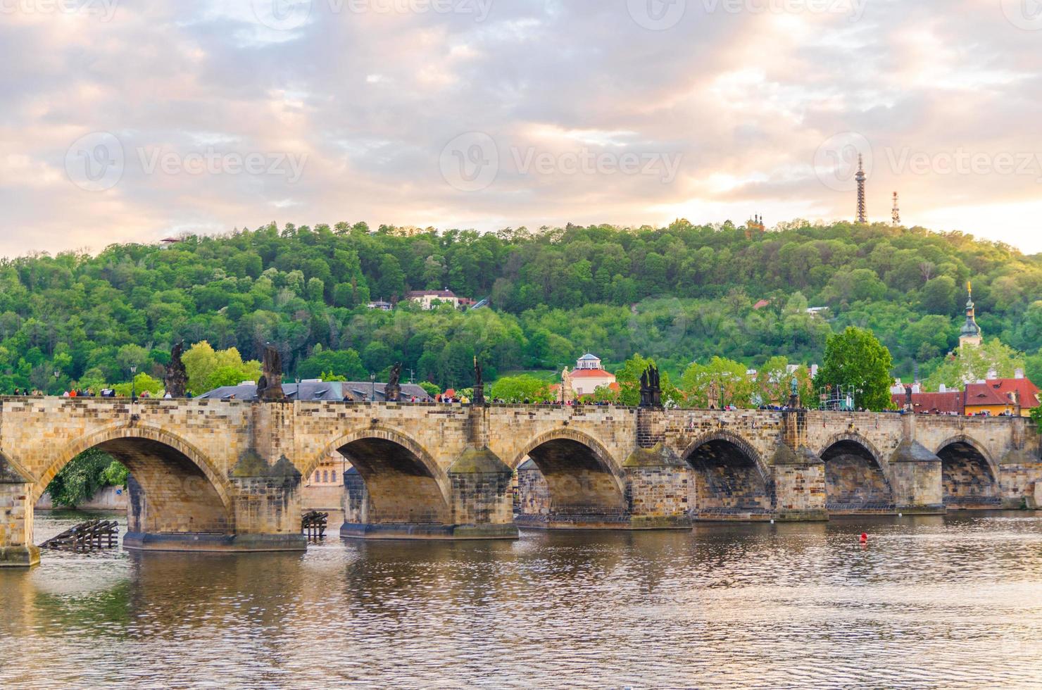 Charles Bridge Karluv Most with alley of dramatic baroque statues over Vltava river in Old Town of Prague photo